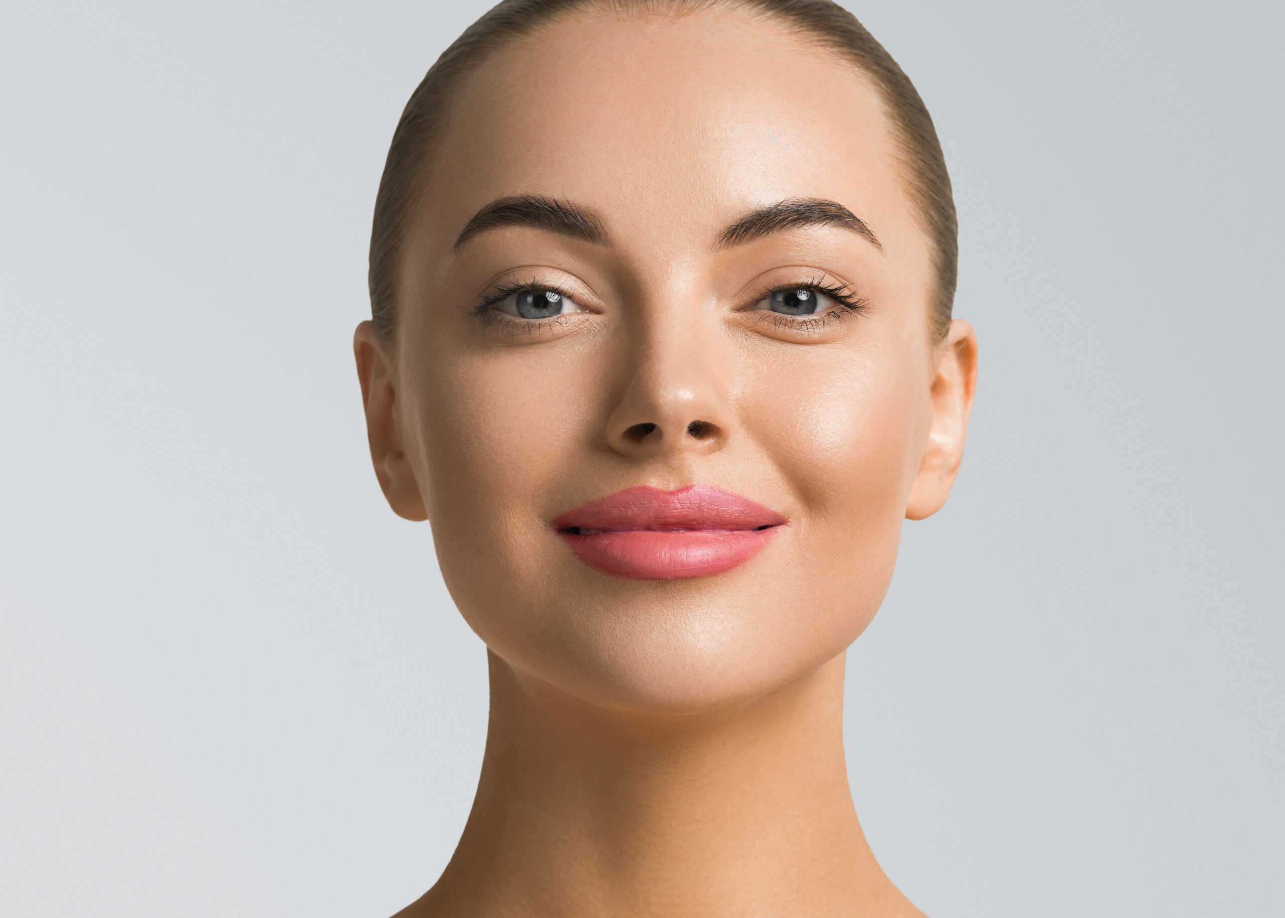 Woman with smooth, rejuvenated facial skin after dermal fillers