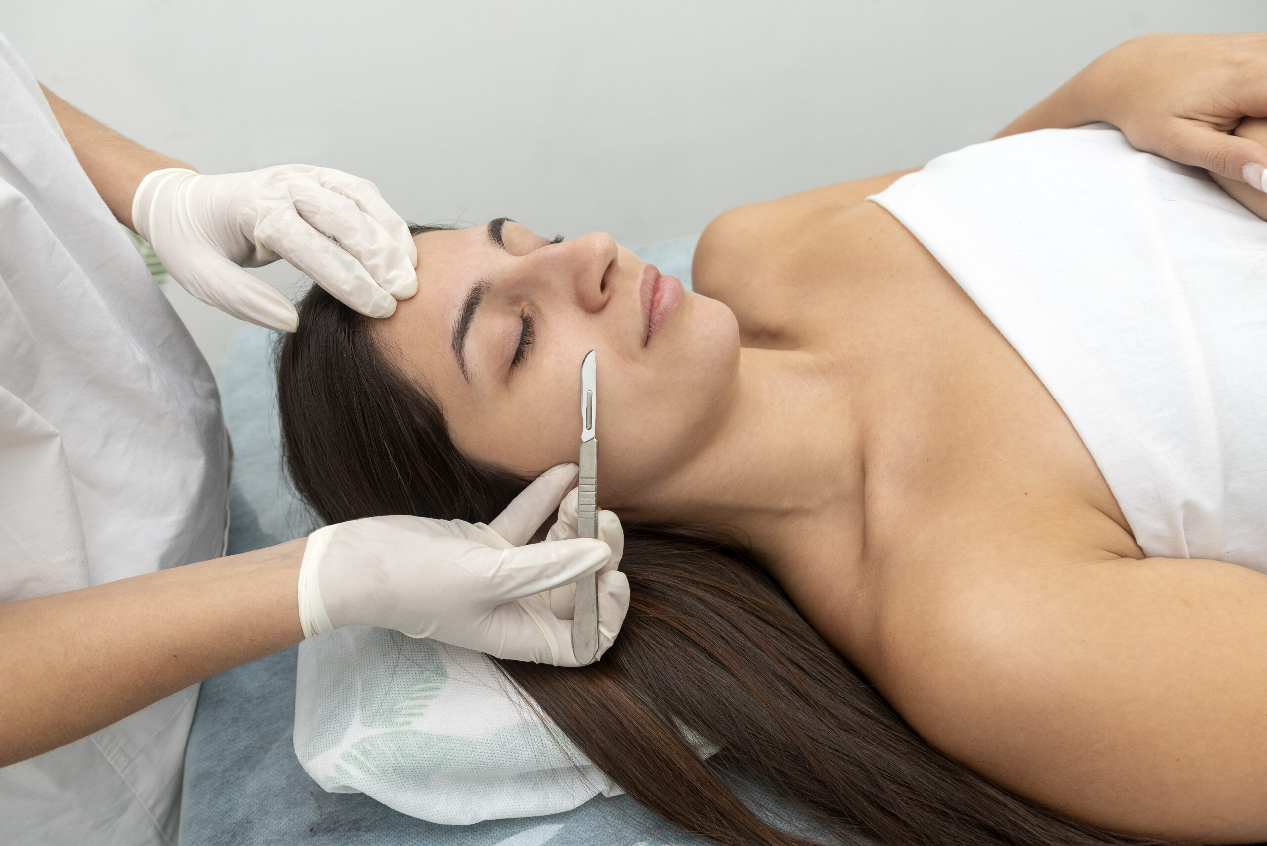 Patient receiving dermaplaning facial treatment